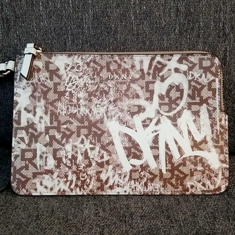 Brand new DKNY medium wristlet. Brown Graffiti pattern. Retails $78